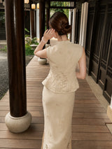 Back view of a beige Cheongsam set featuring a sleeveless top and midi skirt with scalloped lace trim, styled with a hair bun.