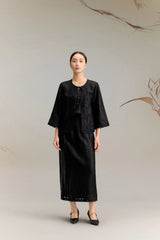 Full body shot of a black silk co-ord set featuring a mid-sleeve jacket top with delicate lace embroidery along the edges and a tie-front closure, paired with a matching A-line midi skirt with lace detailing at the hem, crafted from 100% mulberry silk.