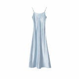 Flat lay of a light blue satin slip dress with a sleek silhouette and delicate shoulder straps, 100% polyester fabric.