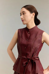 Close-up of a burgundy Qipao-style vest top with a mandarin collar, gold-toned buttons, and decorative contrast stitching, highlighting the premium silk material.