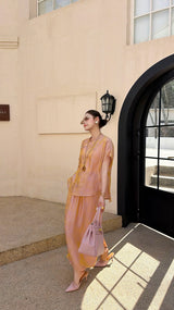 Side view of a champagne gold New Chinese style co-ord set, highlighting the subtle jacquard texture and side slit detail on the maxi skirt.