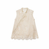 Flat lay of a champagne gold sleeveless vest with bead embroidery, scalloped lace hem, and traditional side button closures.