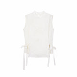 Flat lay of a cream white sleeveless Cheongsam vest with geometric embroidery, side ties, and a front button closure.