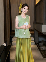 Model wearing a green embroidered Cheongsam vest with a round neck and scalloped lace hem, holding a fan, crafted from 100% polyester.