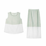 Flat lay of a mint green two-piece set featuring a sleeveless top with beaded trim and a matching midi skirt with embroidered floral details and a sheer white hem.