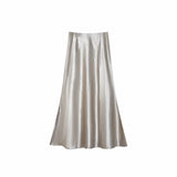 Flat lay of a mocha satin A-line maxi skirt with a high waist and smooth flowing drape, crafted from 100% polyester.