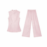 Flat lay of a pink Cheongsam style blouse and trousers set, showcasing the relaxed fit and lace details on the pants.