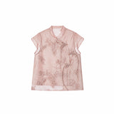 Flat lay of a pink short-sleeve Cheongsam top with a mandarin collar, floral embroidery, and side tie details.