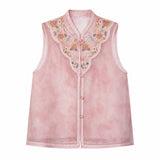 Flat lay of a pink sleeveless Cheongsam vest with a mandarin collar, intricate floral embroidery, and scalloped hem, crafted from 100% polyester.