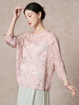 Front view of a women's pink sheer silk blouse with intricate floral cutwork and a relaxed fit, showcasing the lightweight and breathable 100% Mulberry Silk fabric.