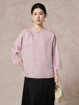 Model wearing a light purple 93.8% mulberry silk blouse with a round neckline, diagonal placket, and intricate jacquard weaving, paired with a black skirt, showcasing a sophisticated New Chinese style look.