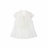 Flat lay of a white lace-trimmed Cheongsam top with a mandarin collar, delicate floral embroidery, and short lace sleeves, crafted from 80% Viscose, 20% Polyamide.
