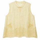Flat lay of a yellow sleeveless Cheongsam vest with a round neckline, gold clasp closure, and intricate scalloped floral embroidery along the hem, crafted from 73% Viscose and 27% Polyester.